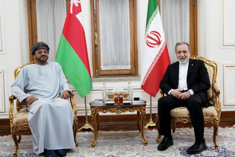 In this photo released by the Iranian Foreign Ministry, Foreign Minister Abbas Araghchi, right, meets his Omani counterpart