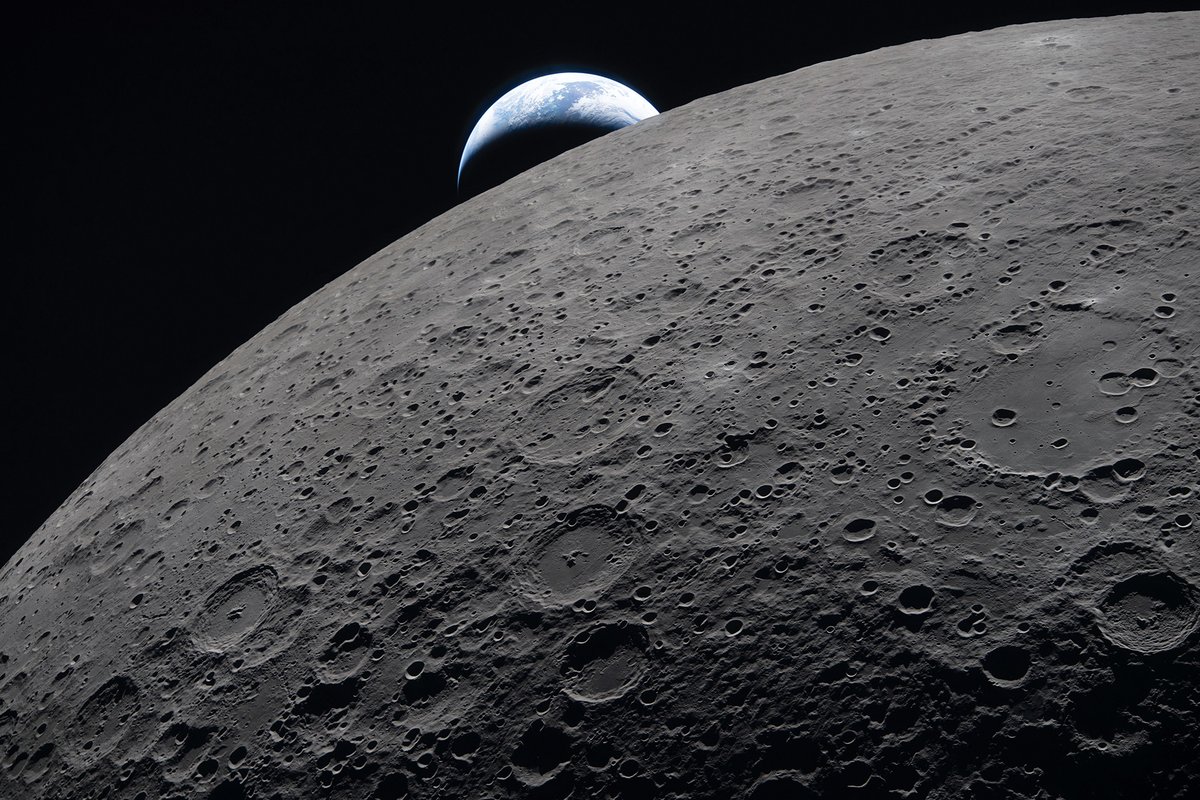The crescent Earth sets against the shadowy, cratered limb of the moon