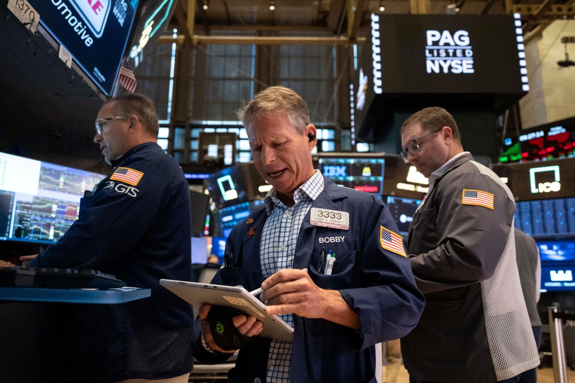 Trader Robert Charmak works on the floor of the New York Stock Exchange