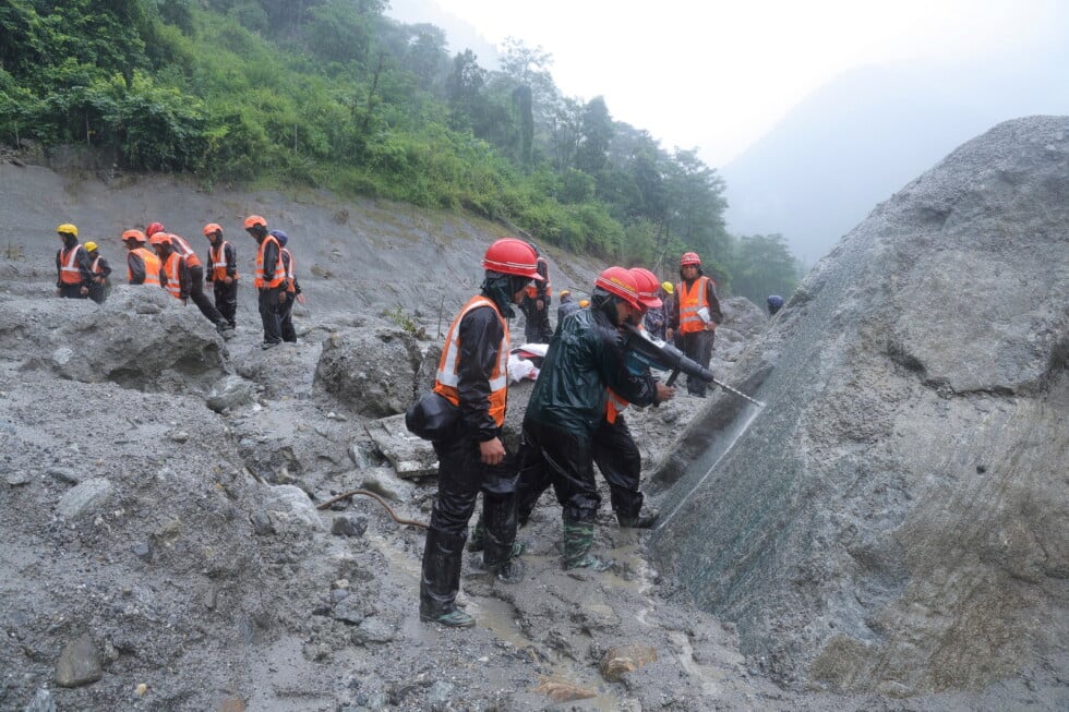 This photo provided by the Nepal Army, shows Nepal army soldiers using a drilling machine during a rescue operation at the